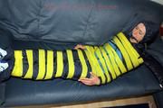 Katharina taped and gagged in a blue nylon rainsuit