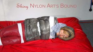 ***NEW MODEL*** Sandra wearing highheels and a sexy red crazy sensation skibib as well as a grey down jacket tied and gagged on a sofa with tape (Pics)