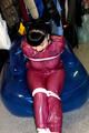 Jill tied and gagged in a semi-transparent purple PVC suit