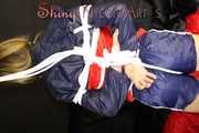 SANDRA being tied and gagged overhead with ropes and a clothgag wearing a sexy oldschool shiny nylon shorts and a rainjacket (Pics)