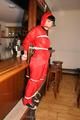 Jill bound in a red nylon rainsuit
