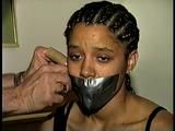 18 Yr OLD STUDENT SHANNA IS WRAP TAPE GAGGED, DUCT TAPE TIED, BAREFOOT, TOE-TIED, HANDCUFFED, MOUTH STUFFED, HANDGAGGED WHILE SITTING ON THE BED (D67-15)
