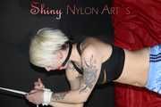 Watching ***NEW MODELL COURTNEY*** wearing a sexy lightblue shiny nylon shorts and a black top being tied and gagged overhead with ropes and a ballgag (Pics)