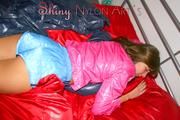 Alina preparing her bed for relaxing and lolling on the bed wearing sexy shiny nylon shorts and a rain jacket (Pics)