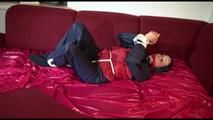Lucy tied, gagged and hooded on a sofa wearing an oldschool rainwear combination (Video)