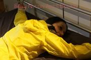 Lucy tied and gagged on bedposts face-down position wearing a sexy yellow shiny nylon shorts and a yellow rain jacket (Pics)