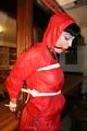 Jill bound in a red nylon rainsuit