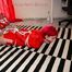 Marlin tied and gagged in red nylon shorts and red cagoule