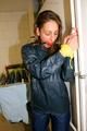 Stella tied and gagged in a shiny blue rainsuit