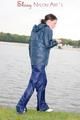 Sexy archive girl wearing a blue rain pant and rain jacket walking on a lake in freetime (Pics)