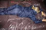 Watching Sandra wearing shiny nylon rainwear while preparing bed and feeling good in that stuff showing her sexy bud (Pics)