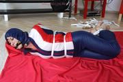 Julia tied and gagged in a shiny nylon skisuit