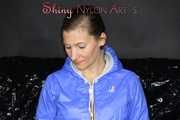 Sexy Sandra wearing a supersexy black shiny nylon rain pants and a sexy shiny blue rain jacket lolling on the sofa (Pics)