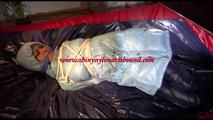 Lulu tied and gagged on a bed wearing a sexy blue shiny nylon rainpants and a iceblue PAMY downjacket (Video)