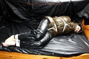 Jill tied and gagged in a shiny nylon down coat