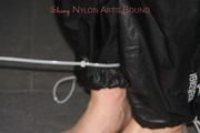 Jill tied and gagged on the bed with cable binders in a black shiny nylon pant and an red/Blue shiny rain jacket (Pics)