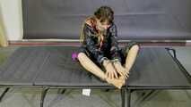 Lana handcuffed and gagged wearing a shiny nylon Windbreaker
