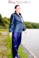 Sexy archive girl wearing a blue rain pant and rain jacket walking on a lake in freetime (Pics)