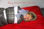 ***NEW MODEL*** Sandra wearing highheels and a sexy red crazy sensation skibib as well as a grey down jacket tied and gagged on a sofa with tape (Pics)