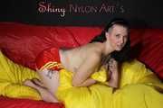 Watching Mara wearing ONLY a hot red shiny nylon shorts posing and lolling on a sofa (Pics)