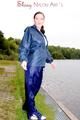 Sexy archive girl wearing a blue rain pant and rain jacket walking on a lake in freetime (Pics)