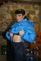 Jill posing in a cooling room wearing a shiny nylon rainpants and a down jacket (Pics)