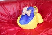 Sonja tied, gagged and hooded on a sofa wearing a sexy blue rain pants and a yellow downwear jacket (Pics)