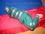 Jill tied, gagged and hooded on a sofa with tape wearing supersexy shiny nylon oldschool rainwear (Pics)