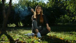 Beautiful Yulia is smoking all white cigarette