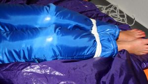 Alina tied and gagged in a shiny skisuit
