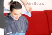 Jill tied, gagged and hooded with ropes on as sofa wearing a blue shiny nylon shorts and a blue oldschool rain jacket (Pics) 