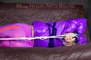 *** HOT HOT HOT*** NEW MODELL*** SANDRA wearing a sexy transparent purple shiny nylon pants and a purple down jacket tied and gagged on a sofa with ropes hand to feet and a cloth gag (Pics)