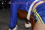 Watching sexy Sonja wearing a sexy shiny nylon shorts in blue and a blue rain jacket being tied and gagged on a stool with ropes and a clothgag (Pics)