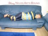 Leoni tied, gagged and hooded with tape wearing a sexy blue rainwear combination (Pics)