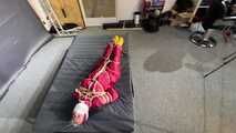 Alice bound and gagged in a nylon Rainsuit
