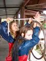 two of our archive girls in shiny nylon rainwear and bondage