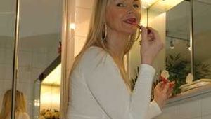 Busty mature Marlen posing in white shirt and stockings in bathroom