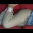 Julia tied and gagged on a sofa wearing a shiny light blue/beige PVC suit (Video)