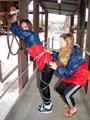 two of our archive girls in shiny nylon rainwear and bondage