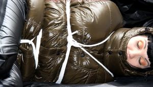 Jill tied and gagged in a shiny nylon down coat