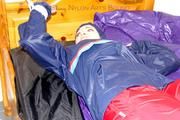 Jill tied and gagged in shiny nylon rainware