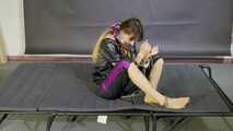 Lana handcuffed and gagged wearing a shiny nylon Windbreaker