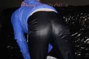 Sexy Sandra wearing a supersexy black shiny nylon rain pants and a sexy shiny blue rain jacket lolling on the sofa (Pics)