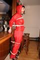 Jill bound in a red nylon rainsuit