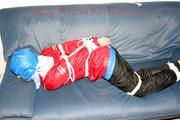 Jill tied, gagged and hooded on the sofa wearing a sexy black shiny nylon pants and two rain jackets (Pics)