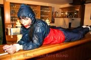 Jill tied and gagged in shiny rainwear