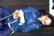 Lucy tied with cuffs overhead and gagged with a clothgag wearing sexy blue rain pants and a raincoat (Pics)