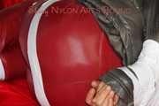 ***NEW MODEL*** Sandra wearing highheels and a sexy red crazy sensation skibib as well as a grey down jacket tied and gagged on a sofa with tape (Pics)