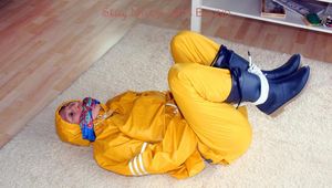 Katharina tied and gagged in a yellow rainsuit