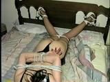 40 Yr OLD HAIRDRESSER CHER IS TIED FACE DOWN ON BED WITH KNEES TIED TOGETHER & NYLON COVERED FEET TIED 3 FEET APART TO HEADBOARD & IS CLEAVE GAGGED (D53-11)